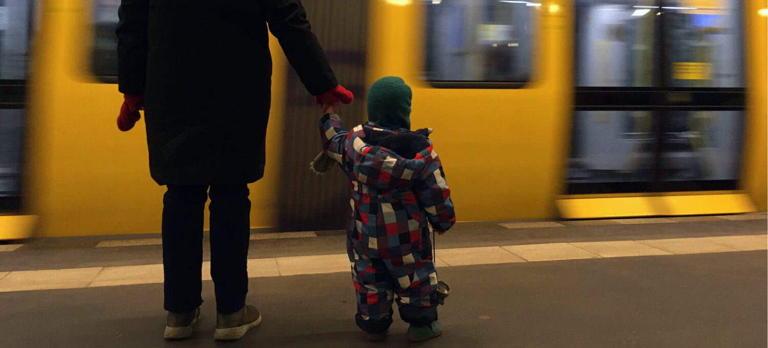 Mama mit Kind vor U-Bahn